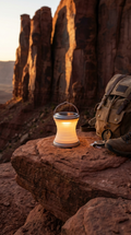 Solar LED Camping Lantern glowing on canyon rock at golden hour